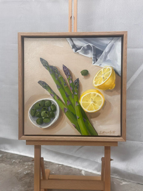 Harvest framed in wooden oak featuring asparagus, lemons and olives
