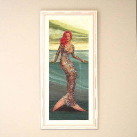 mermaid with long bright red hair in evening gown against the sea